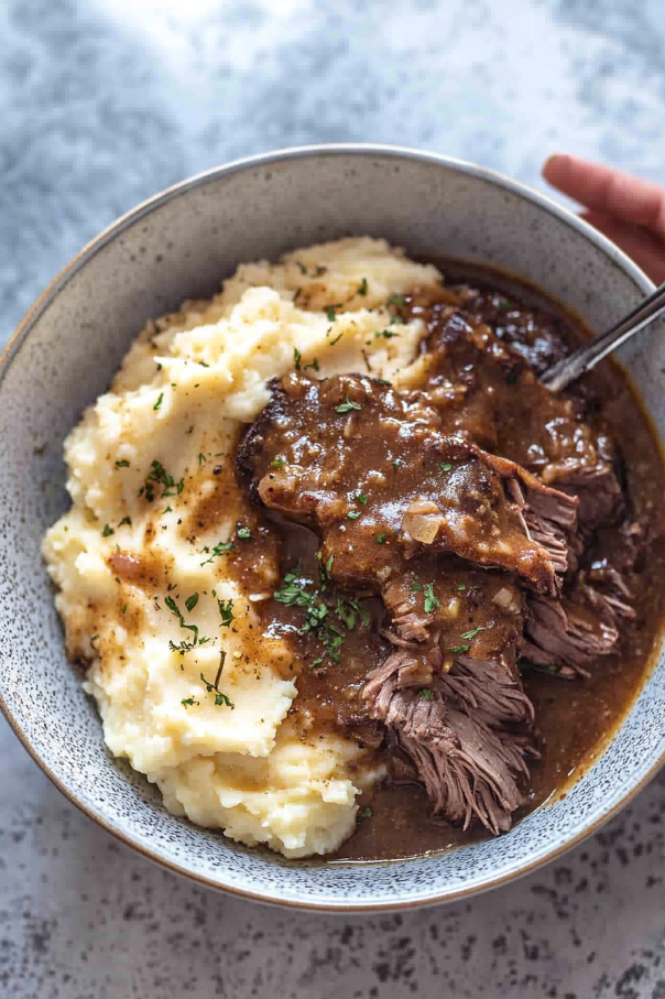 meat and gravy over mashed potatoes